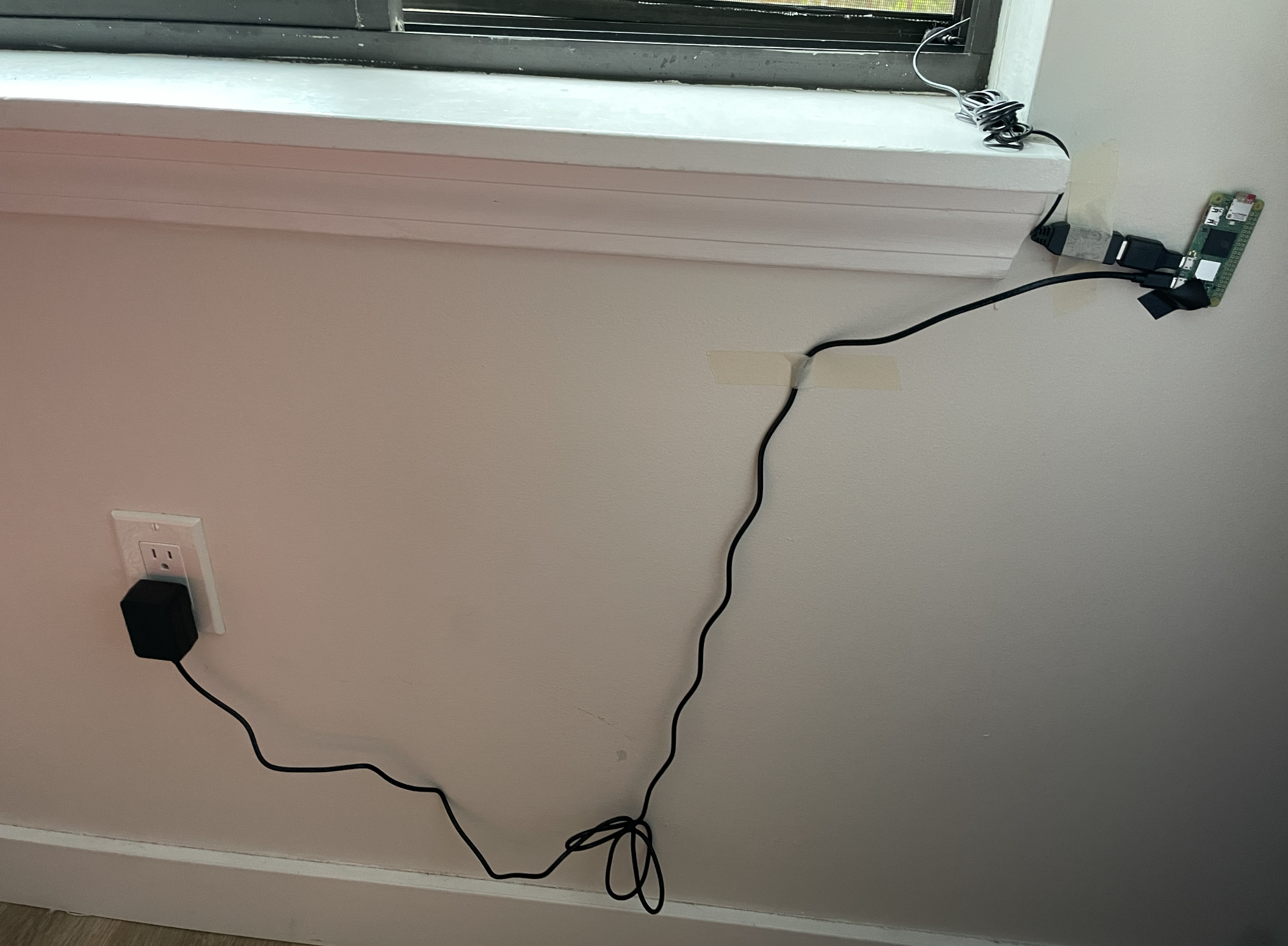 Photo of Raspberry Pi Zero 2 W taped to a wall