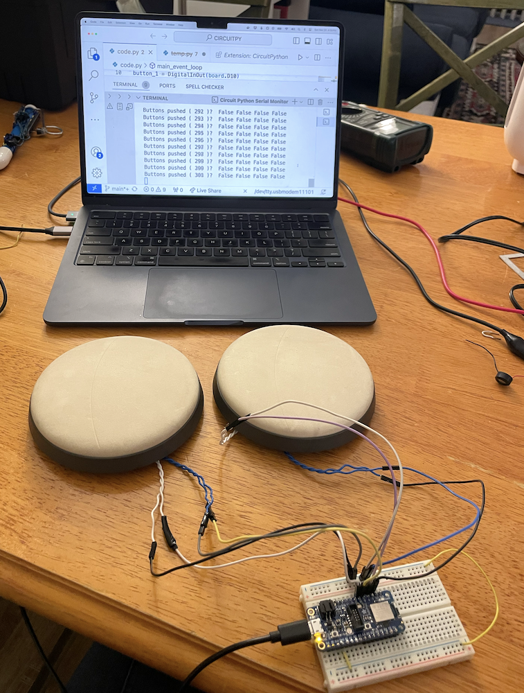 Photo of the drumheads connected to a breadboard, which is connected to a computer
