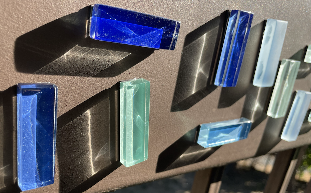 Close up of a few mosaic magnets with dramatic sunset light