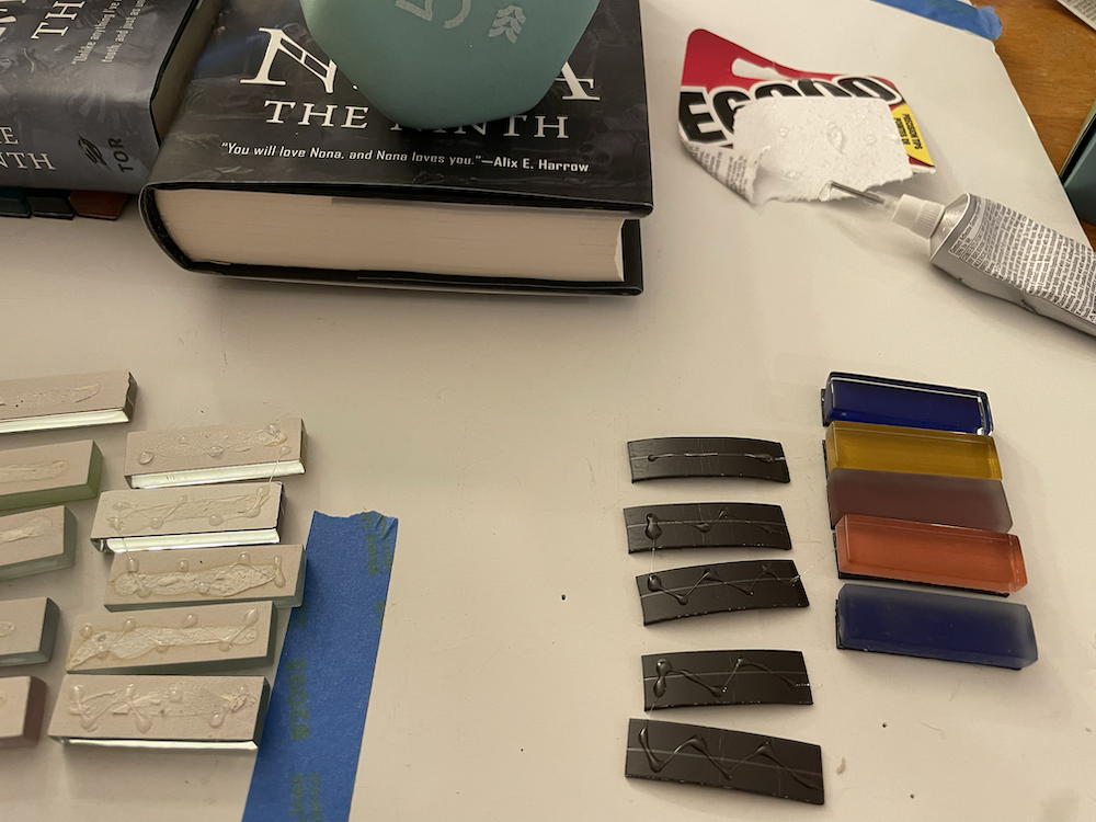 Photo of magnet assembly process: glue, books for weights, magnet strips