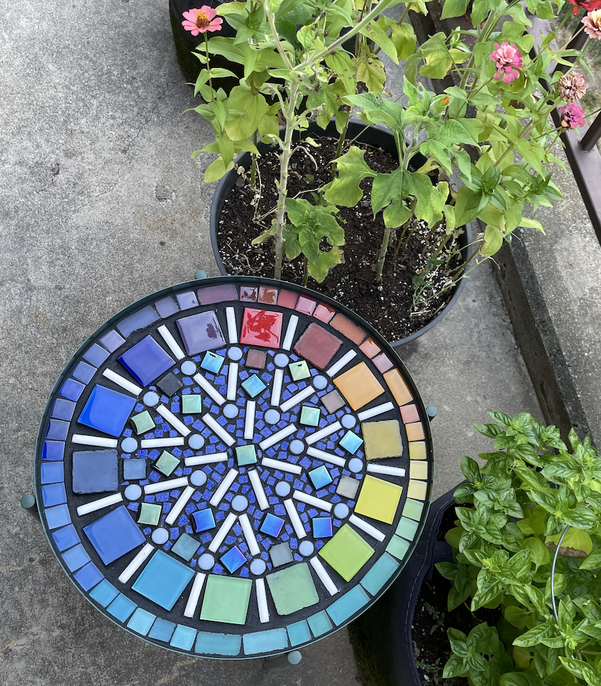 Photo of mosaic table outside, from above
