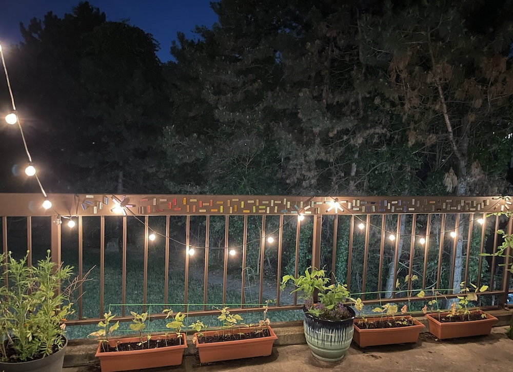 Photo of rainbow mosaic railing at night