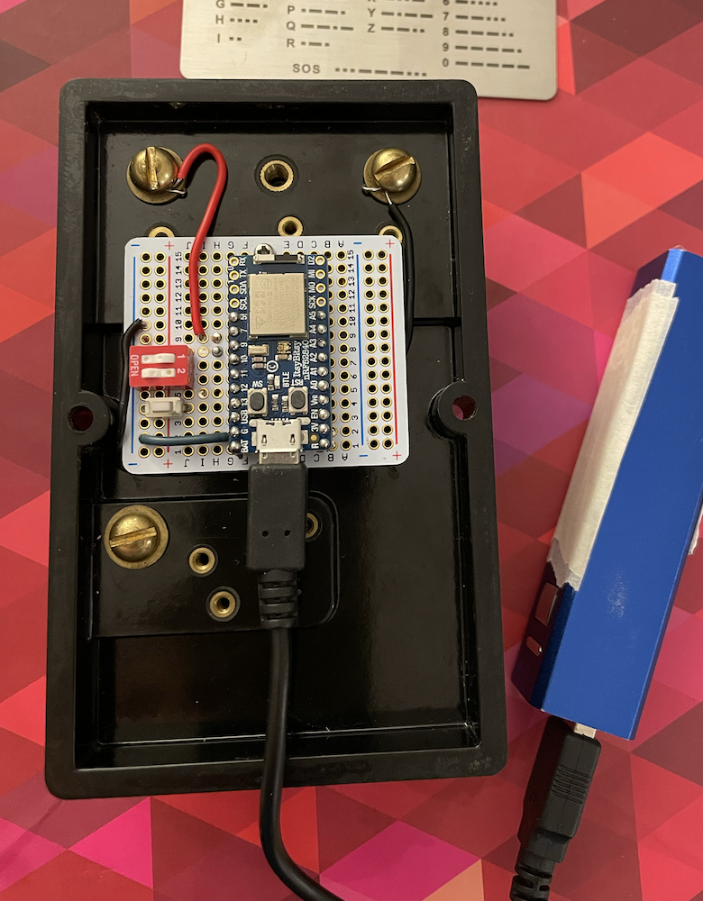 Photograph of back of telegraph key, showing attached microcontroller